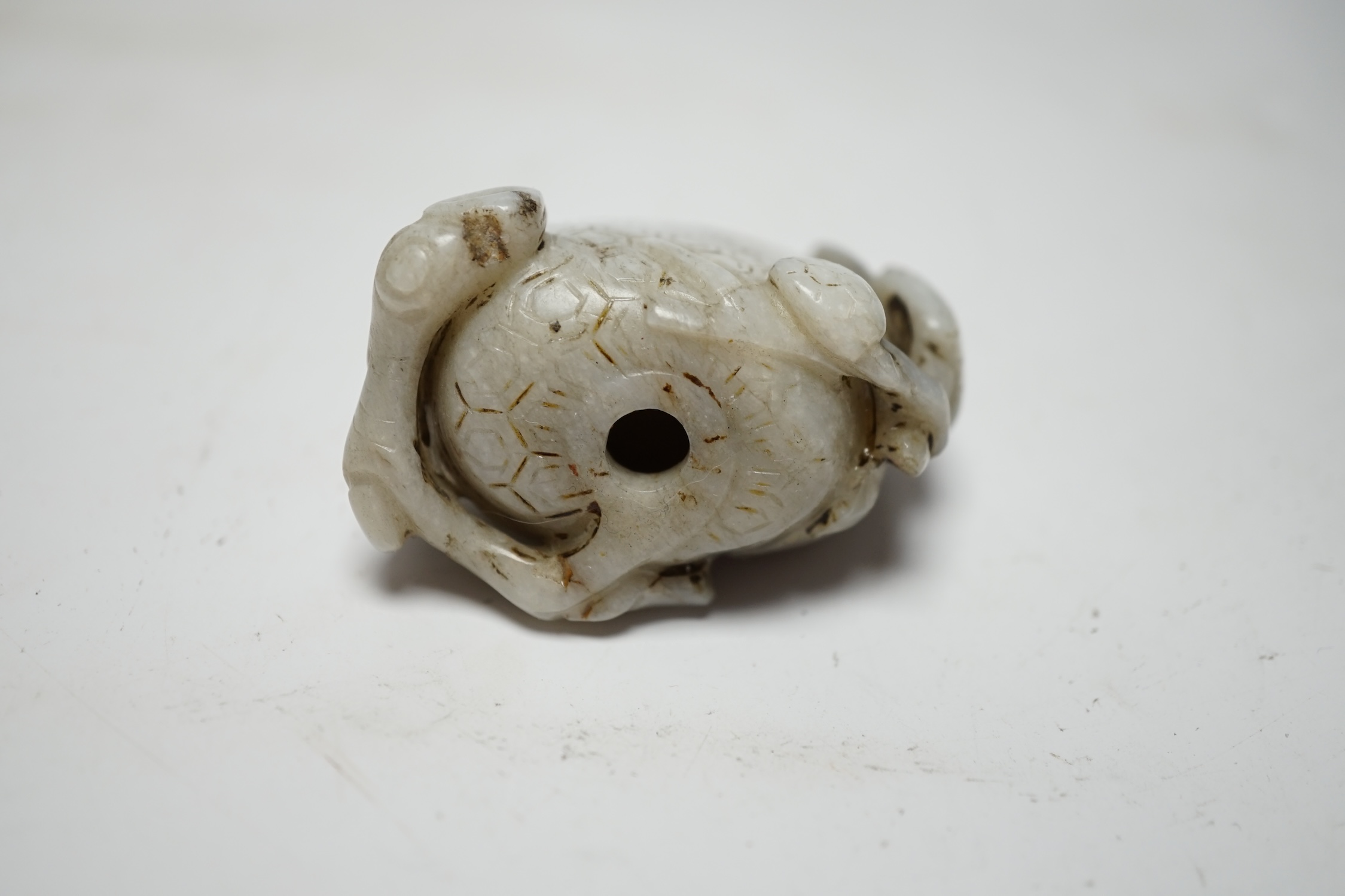 A Chinese carved white and black jade fruit shaped snuff bottle, 6cm high
